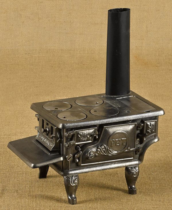 Ideal Mfg. Co. cast iron and tin Pet toy stove,: Ideal Mfg. Co. cast iron and tin Pet toy stove, 6 3/4'' h., 11 3/4'' w.