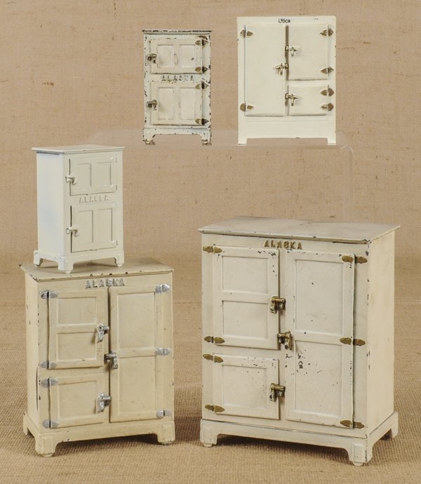 Four Arcade cast iron Alaska refrigerators, lar: Four Arcade cast iron Alaska refrigerators, largest 9 1/4'' h., 7'' w., together with one marked Utica.