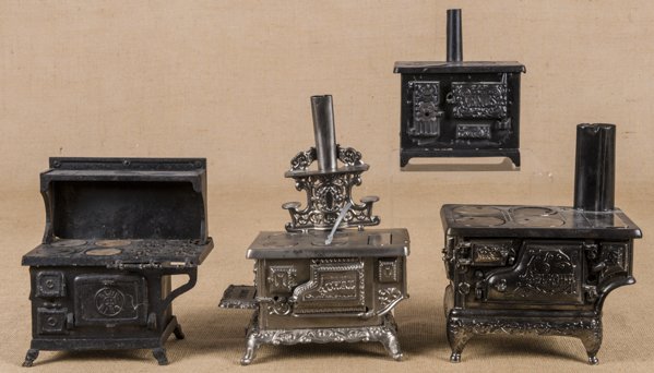 Four cast iron and nickel toys stoves, to include: Four cast iron and nickel toys stoves, to include a Delight, 6 1/4'' h., 8 3/4'' w., a Royal, 5 1/4'' h., 11'' w., a Kenton Venus, 5'' h., 6'' w., and a Grey Iron Blue Bird combination, 9'' h., 8'' w.