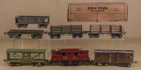 Ives standard gauge seven-piece train set, to inc: Ives standard gauge seven-piece train set, to include a #3241 Engine, a #192 Boxcar, a #193 Stock car, a #196 Flat Bed, a Dump car, and two #191 Coke cars, one with its original box.