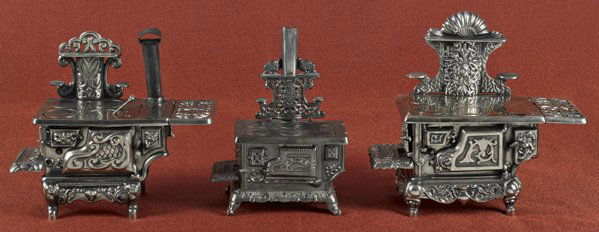Three cast iron and nickel toy stoves, to include: Three cast iron and nickel toy stoves, to include a Hubley Eagle, 9 1/2'' h., 8 1/2'' w., a Superior, 11'' h., 13'' w., and an Ideal Sterling, 12 1/4'' h., 13 1/2'' w.