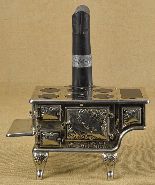 Ideal Mfg. Co. cast iron and tin Baby toy cook stove,: Ideal Mfg. Co. cast iron and tin Baby toy cook stove, 9'' h., 16'' w.