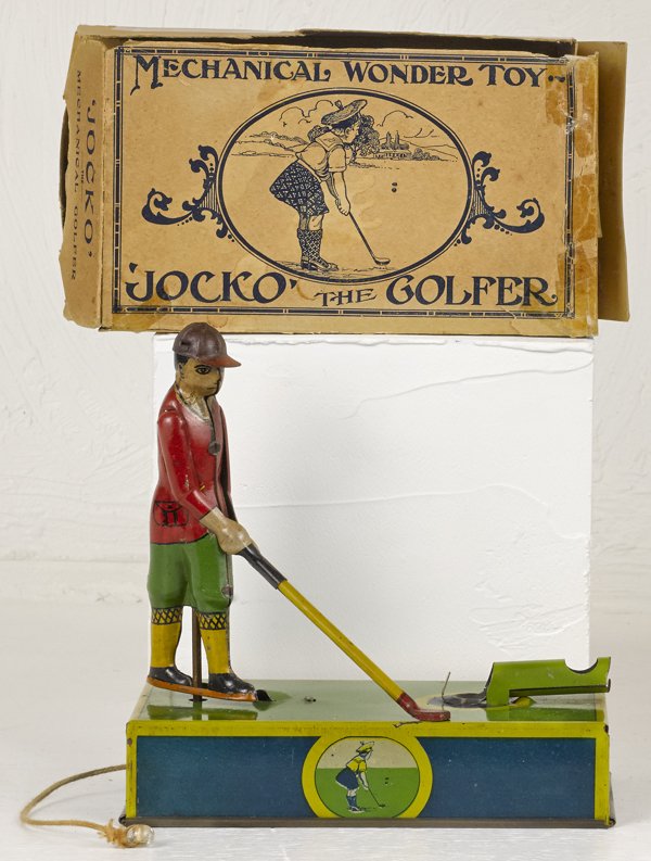 Painted tin wind-up Jocko the Golfer, 6 1/2'' h.: Painted tin wind-up Jocko the Golfer, 6 1/2'' h., with original box and golf balls.