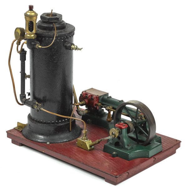 Large cast iron live steam boiler on a platform w: Large cast iron live steam boiler on a platform with a flywheel, 19 1/2'' h., 19'' w., 13'' d.