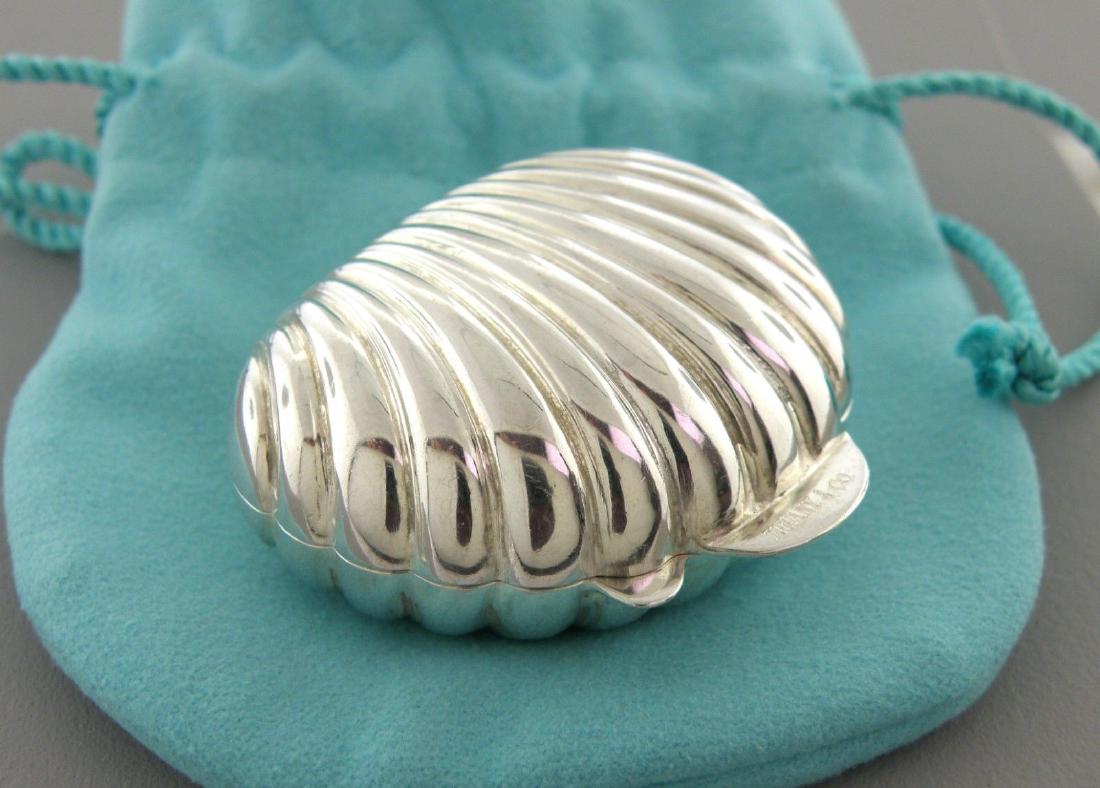 VINTAGE TIFFANY & CO. STERLING SILVER SHELL PILL BOX: VINTAGE TIFFANY & CO. STERLING SILVER PILL BOX Measures 1.87" L x 1.65" W on the outside Sterling silver shell pill box container Vintage, Pre-owned, in good condition, plz refer to pics Stamped TIFFA