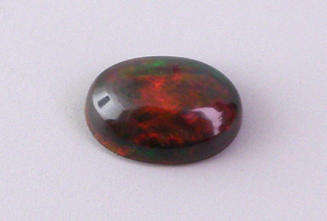 0.85ct AFRICAN BLACK OPAL OVAL CABOCHON CUT NATURAL (1 of 2)