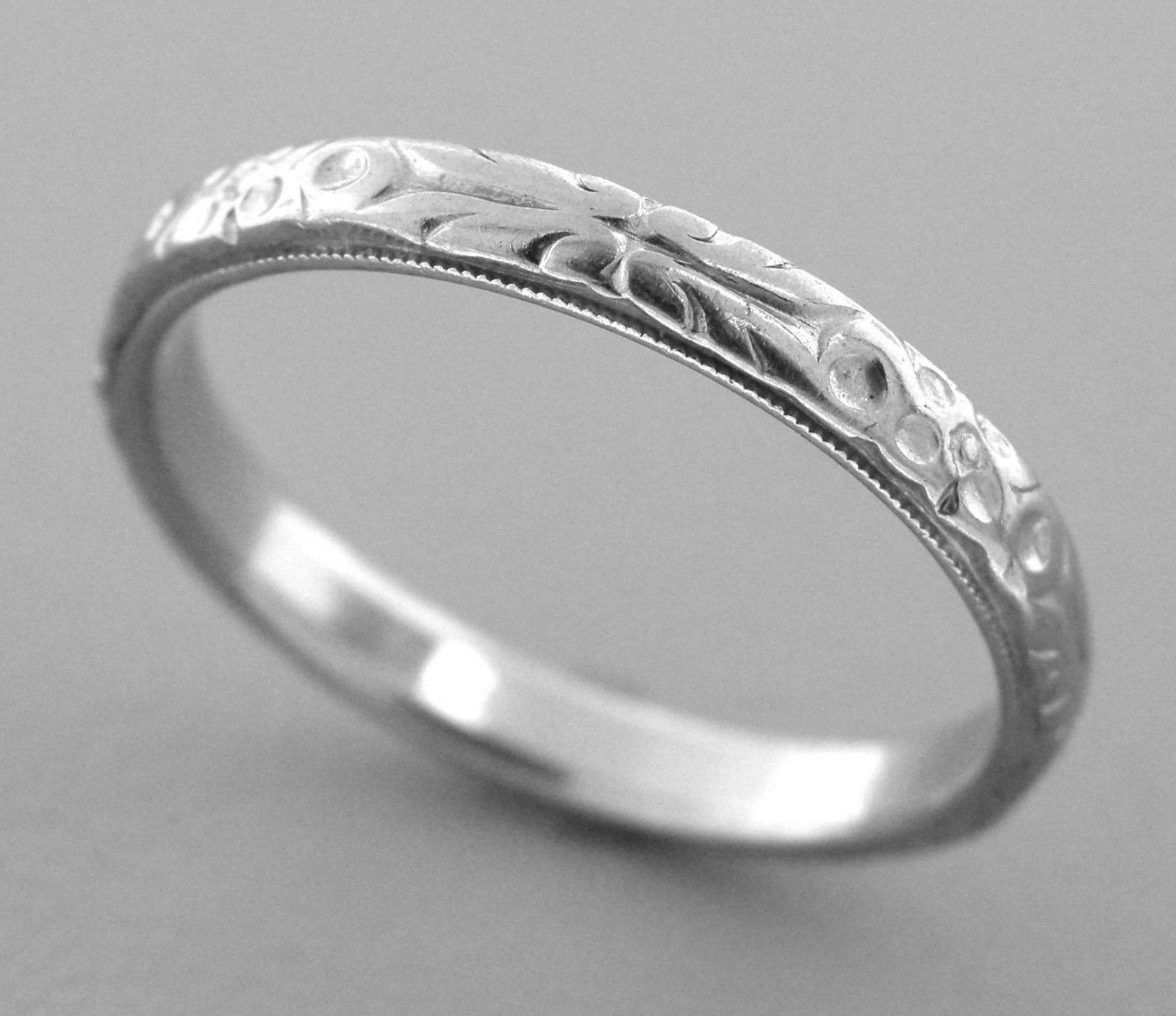 18K WHITE GOLD RING ETERNITY FLOWER DESIGN BAND: Ring size is a 7 Ring measures 2.7mm wide 18K white gold wedding band with flower and filigree design pattern all the way round pre-owned ring is in good condition for it's age, please refer to pics S