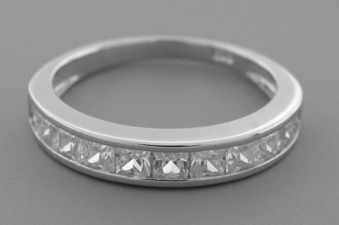 NEW STERLING SILVER CZ HALF ETERNITY WEDDING BAND RING: NEW STERLING SILVER WEDDING BAND RING SIZE 9.25Ring is a size 9.25Half eternity princess cut CZRings measures 3.7 mm wide on topSterling silver, set with CZNewStamped 925Total weight 2.4 grams
