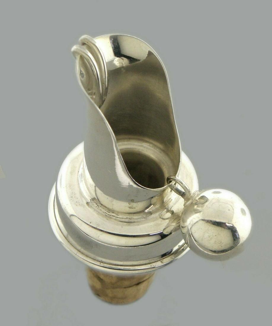 VINTAGE TIFFANY & CO. STERLING SILVER CORK AND SPOUT: TIFFANY & CO. STERLING SILVER CORK SPOUT WITH BALL Measures 2.90" H x 1.35" W Vintage Tiffany & Co. Sterling silver made in Germany Hollow cork, stays in bottle, when pouring ball moves away from hole