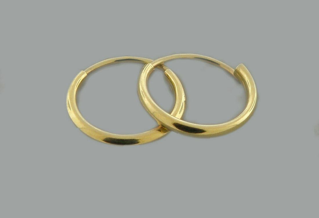 NEW 14K YELLOW GOLD SMALL BABY ROUND TUBE HOOP EARRINGS: NEW 14K YELLOW GOLD EARRINGS New 14K Yellow Gold Hoop Earrings Measures: 1.2mm Wide x 10mm in Diameter Small baby size Earrings have a polished finish Endless Back Stamp: 14k Avg Weight: 0.3g