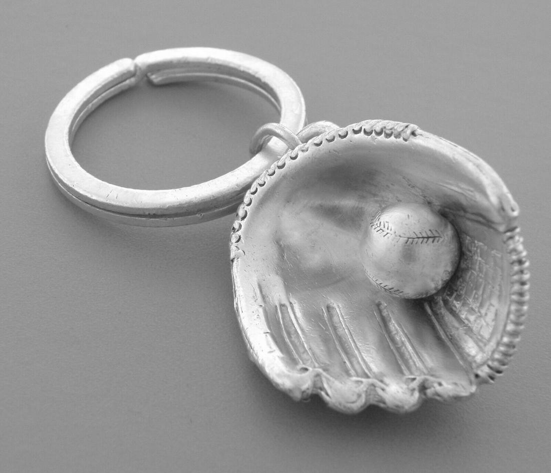TIFFANY & CO. STERLING SILVER BASEBALL KEYRING: TIFFANY & Co. STERLING SILVER KEYRING Keyring measure 2.73" H x 1.16" W Tiffany & Co. sterling silver baseball keyring Pre-owned in good working condition, shows wear, please refer to pics Stamped TIF