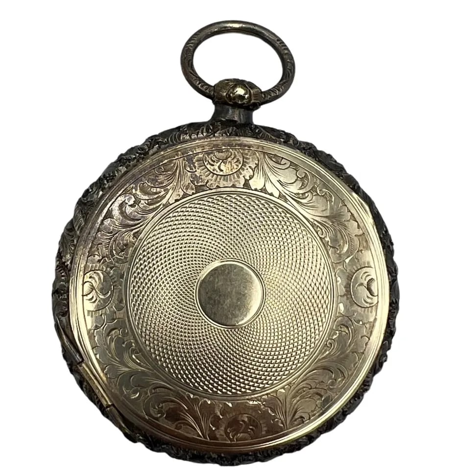 Victorian Gold and Silver Pill Box Locket Pendant: A beautiful Victorian gold and silver pill box and locket pendant, with the floral metal work. The piece consists of a silver frame and two yellow gold disks attached to the frame by hinges. The silve