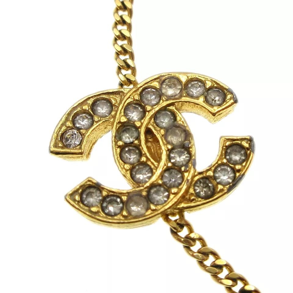 CHANEL RHINESTONE GOLD CHAIN BRACELET 4022/1982: CHANEL RHINESTONE GOLD CHAIN BRACELET 4022/1982 CONDITION Exterior : A : GOOD CONDITION!! Scratched, Discoloration Number :- Size (Inch) : Inner circumference : 8.3 " Width : 0.8 " Size (CM) : Inner c