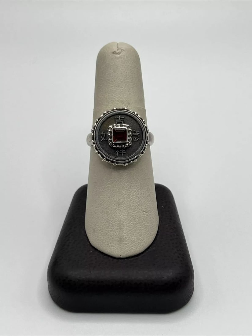 SAJEN "GOOD LUCK" CHINESE COIN AND GARNET SILVER RING: SAJEN "GOOD LUCK" CHINESE COIN AND GARNET SILVER RING Embrace the essence of Luck with this beautiful Sajen Chinese Coin and Garnet Silver Ring. Crafted with 925 metal purity, this adjustable ring fea