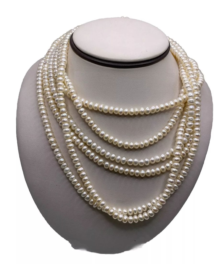 100" FRESH WATER PEARL NECKLACE (7 WAYS TO STYLE INCLUDED): This 100" Freshwater Pearl Necklace is a stunning piece of jewelry designed to be worn as a necklace. It features beautiful white freshwater pearls arranged in a beaded style, creating an elegant and