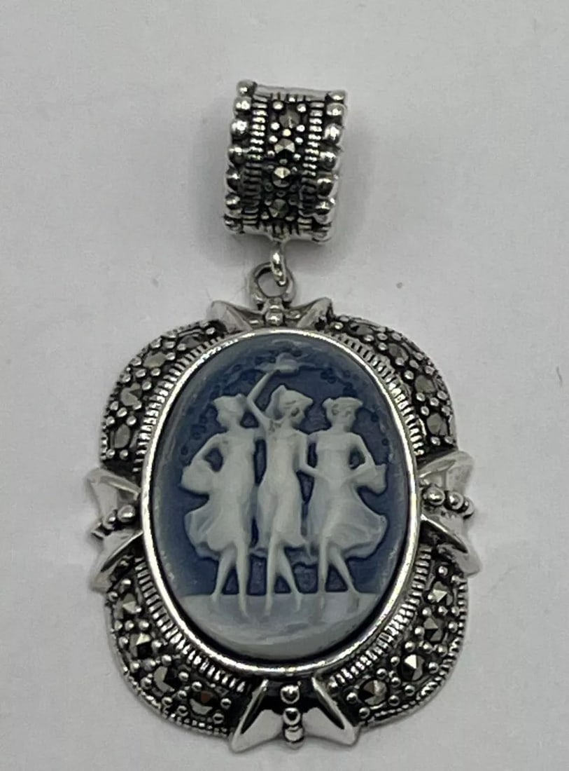 STERLING SILVER 925 MARCASITE DANCING GIRLS PENDANT: This pendant features a dancing girl design made of Sterling Silver 925 adorned with Marcasite stones. The intricate details and sparkling Marcasite stones add a touch of elegance and charm to the pie