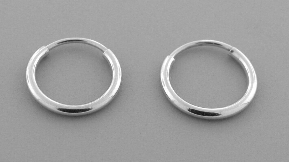 NEW 14K WHITE GOLD SMALL ROUND TUBE HOOP EARRINGS: NEW 14K WHITE GOLD EARRINGS New 14K White Gold Hoop Earrings Measures: 1.2mm Wide x 10mm in Diameter Earrings have a polished finish Endless Back Stamp: 14k Avg Weight: 0.3g