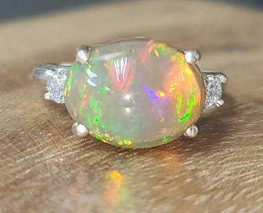 VINTAGE 14K WHITE GOLD ENGAGEMENT RING 4.18CT. NATURAL ETHIOPIAN OPAL CABOCHON: VINTAGE 14K WHITE GOLD ENGAGEMENT RING 4.18CT. NATURAL ETHIOPIAN OPAL CABOCHON Vintage 14K WHITE GOLD OPAL RING CENTER SET NATURAL ETHIOPIAN OVAL CABOCHON SHAPE WEIGHT 4.18CARAT SIZE 13x10MM NATURAL O