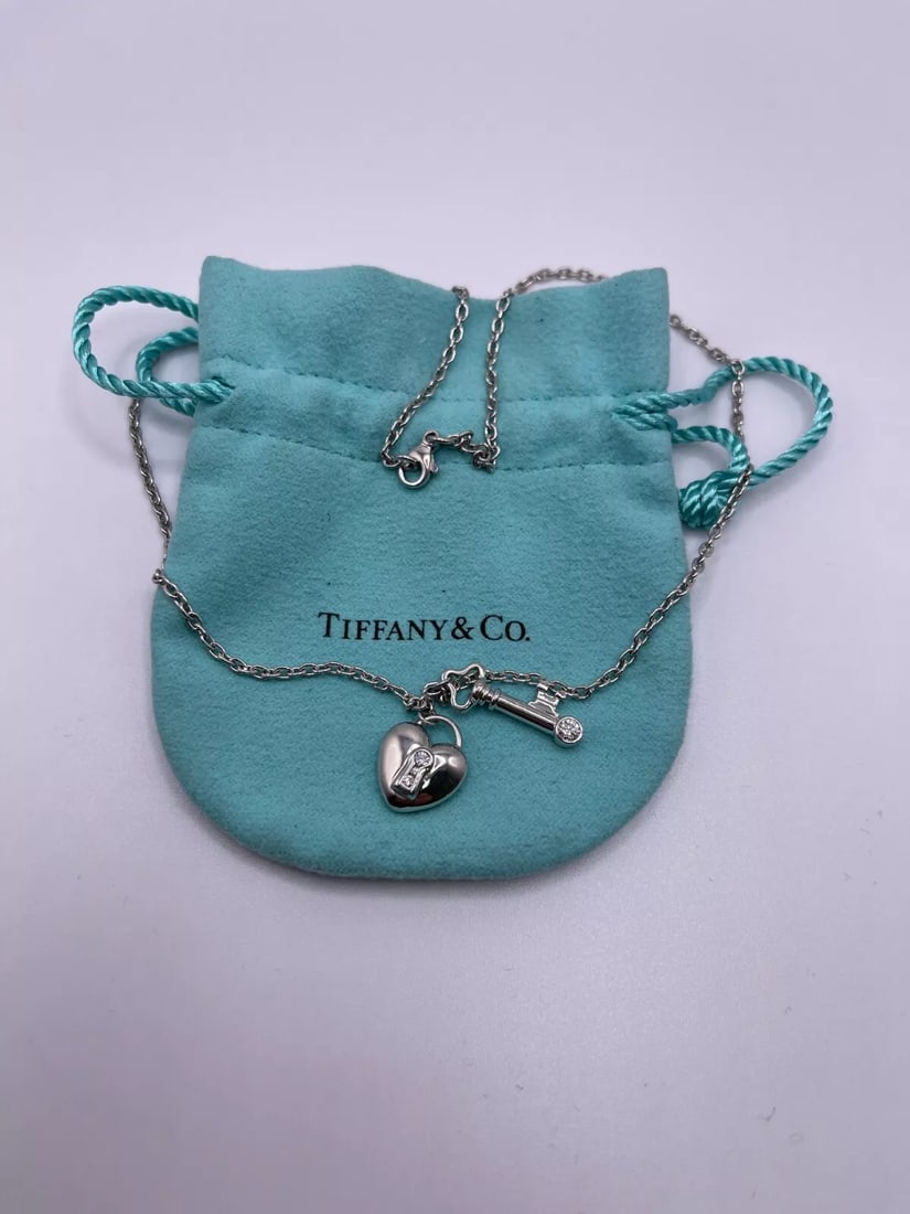TIFFANY & CO. PLATINUM HEART LOCK AND KEY DIAMOND PENDANT NECKLACE - 16" LONG: Tiffany & Co. Platinum 950 Heart Lock and Key Diamond Pendant Necklace Length - 16" Long Total Weight - 17.2 Grams Professionally Polished & Looks Brand New Pouch Included Bid With Confidence Feel Fre