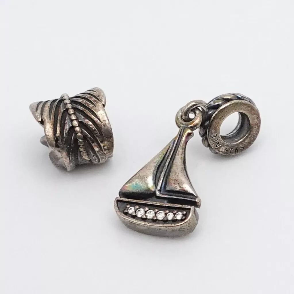 AUTHENTIC PANDORA STERLING SILVER SAIL AWAY BOAT CLEAR CZ & FEATHER CHARMS: PANDORA STERLING SILVER SAIL AWAY BOAT CLEAR CZ & FEATHER RETIRED CHARMS Authentic Pandora Sterling Silver Sail Away Boat Clear Cubic Zirconia & Feather Retired Charms Style # 791138CZ & 790581 Total