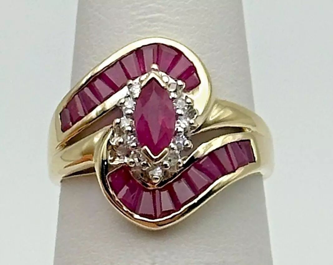 10K GOLD MARQUISE COCKTAIL RING WITH NATURAL RUBIES AND 0.18CTS OF DIAMONDS (1 of 2)