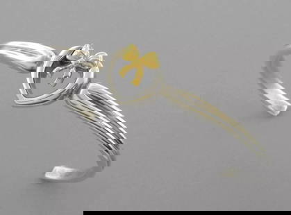 TIFFANY & CO. 18K GOLD STERLING SILVER BOW CUFF BRACELET WITH POUCH: TIFFANY & CO. 18K STERLING SILVER BOW CUFF Tiffany & Co. 18K Sterling silver bow cuff Bracelet Will fit a 6.25" wrist Measures 0.53" wide in front Pre-owned, in good condition, please refer to pics Po