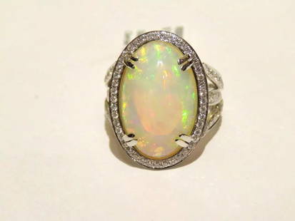 EXQUISITE LRG CERTIFIED 9CT FIRE OPAL AND WHITE DIAMOND RING: EXQUISITE LRG CERTIFIED 9CT FIRE OPAL AND WHITE DIAMOND RING The Following Item we are offering is this Beautiful 18KT White Large Oval Fire Opal and Diamond Cocktail Bombe Ring