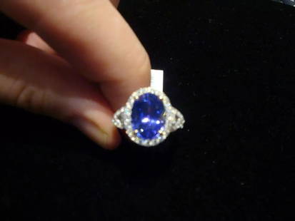 18KT GOLD LARGE TANZANITE AND DIAMOND RING: 18KT GOLD LARGE TANZANITE AND DIAMOND RING 18KT GOLD LARGE TANZANITE AND DIAMOND RING Last CallLast Call The Following Items we are offering is a Important Radiant Rare 18KT White Gold Flawless