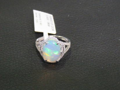 18KT GLITTER FIERY WHITE OPAL DIAMOND RING: 18KT GLITTER FIERY WHITE OPAL DIAMOND RING The Following Item we are offering is a Rare Important Radiant 18KT Gold Large Fancy Fiery White Opal Diamond Ring. Ring is comprised of A LARGE Gorgeous