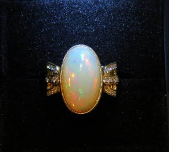 18KT LRG 9CT FIRE OPAL AND WHITE DIAMOND RING: 18KT LRG 9CT FIRE OPAL AND WHITE DIAMOND RING The Following Item we are offering is this Beautiful 18KT Yellow Gold Large Oval Fire Opal and Diamond Cocktail Bombe Ring