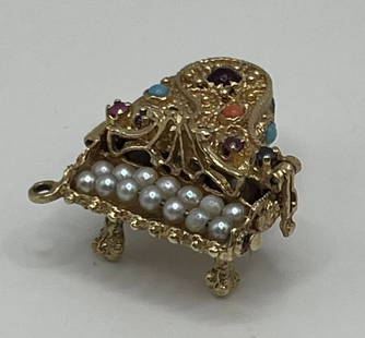 VINTAGE 14K BABY GRAND PIANO CHARMS WITH PEARLS & MULTI-COLORED STONES: VINTAGE 14K BABY GRAND PIANO CHARMS WITH PEARLS & MULTI-COLORED STONES Vintage 14K Baby Grand Piano Charm is a unique piece of jewelry that is a must-have for music lovers. The charm is made of yellow