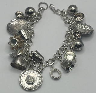 7.5" STERLING SILVER CHARM BRACELET WITH 17 CHARMS MIDWEST/MEXICAN INSPIRED: 7.5" STERLING SILVER CHARM BRACELET WITH 17 CHARMS MIDWEST/MEXICAN INSPIRED This 7.5" Sterling Silver Charm Bracelet features a collection of 17 charms inspired by the Midwest and Mexican culture. Cra