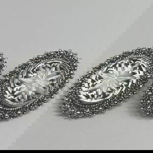 JERUSALEM SILVER CLIP EARRINGS WITH CARVED MOTHER OF PEARL FLOWER DESIGN: JERUSALEM SILVER CLIP EARRINGS WITH CARVED MOTHER OF PEARL FLOWER DESIGN These statement clip earrings are crafted in silver with a vintage Jerusalem design featuring a carved mother of pearl flower.