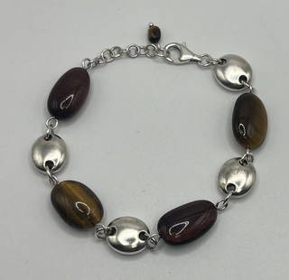 STERLING SILVER & TIGERS EYE 7" ADJUSTABLE BRACELET: STERLING SILVER & TIGERS EYE 7" ADJUSTABLE BRACELET Elevate your style with this stunning bracelet crafted from 925 sterling silver and adorned with a beautiful tiger's eye stone. The lobster closure