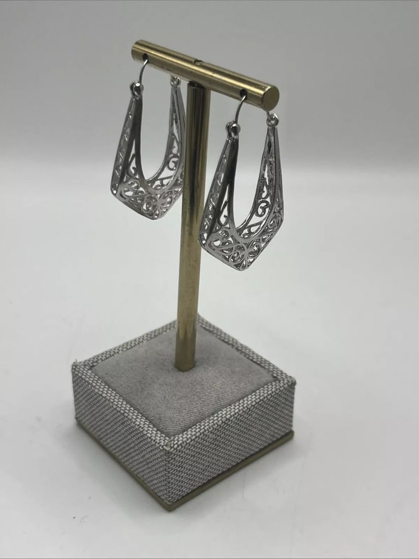 FILIGREE TEARDROP STERLING SILVER HOOPS: FILIGREE TEARDROP STERLING SILVER HOOPS These earrings are elegant Filigree Teardrop Sterling Silver Hoops crafted with a metal purity of 925. The hoops feature intricate filigree work in a teardrop s