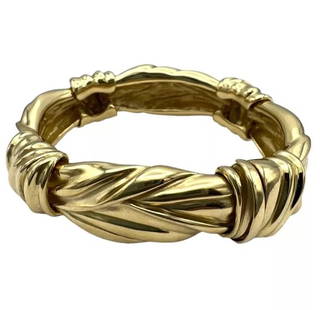 ANGELA CUMMINGS GOLD BANGLE BRACELET CIRCA 1984: ANGELA CUMMINGS GOLD BANGLE BRACELET CIRCA 1984 A glossy Angela Cummings 18k gold bangle bracelet. Stamped with the year of production (1984). It is no exaggeration to say that one of the best example