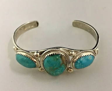 STERLING SILVER CUFF WITH TURQUOISE STONES: STERLING SILVER CUFF WITH TURQUOISE STONES Sterling Silver Cuff with Turquoise Stones You are bidding on a Sterling Silver Cuff with Turquoise Stones. There are few minor scratches on the cuff from no