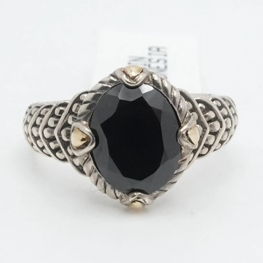 STERLING SILVER 18K GOLD OVAL FACETED BLACK SPINEL RING SIZE 6.25: STERLING SILVER 18K GOLD OVAL FACETED BLACK SPINEL RING SIZE 6.25 Sterling Silver 18K Yellow Gold Accent Oval Faceted Black Spinel Ring Size - 6.25 Band Width - mm Gemstone Size - mm Total Weight - Gr