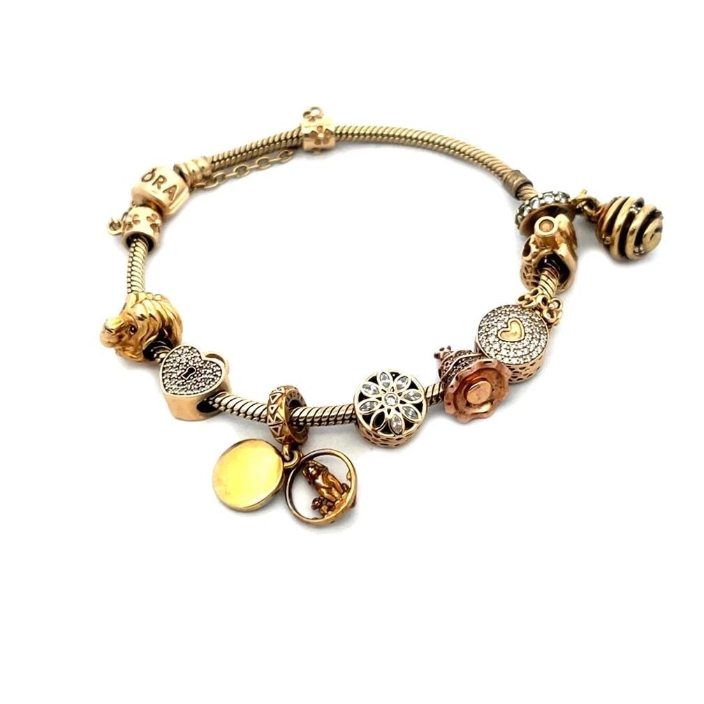 ANDORA GOLD BRACELET 9 SLIDE CHARMS 14K YELLOW SNAKE CHAIN: ANDORA GOLD BRACELET 9 SLIDE CHARMS 14K YELLOW SNAKE CHAIN This authentic and charming bracelet is by Pandora, crafted from 14k yellow gold featuring a 3mm thick snake cable bracelet with 9 assorted s