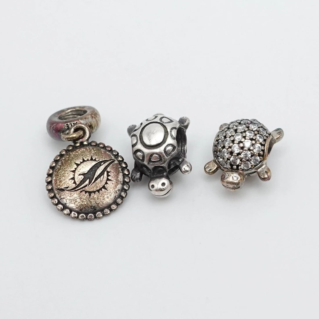 AUTHENTIC PANDORA STERLING SILVER 3 TURTLE & DOLPHIN SEALIFE CHARMS: PANDORA STERLING SILVER LOTS OF 3 TURTLES & DOLPHIN SEALIFE DANGLE CHARMS Authentic Pandora Sterling Silver Lots of 3 Turtles & Miami Dolphin NFL Sealife Retired Dangle Charms Style # 791538cz, 790158