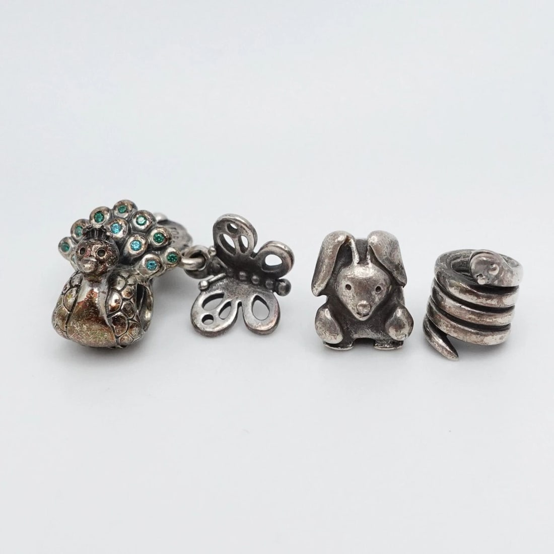 AUTHENTIC PANDORA STERLING SILVER 4 ANIMAL & INSECT RETIRED CHARMS: PANDORA STERLING SILVER LOTS OF 4 BUTTERFLY PEACOCK BUNNY SNAKE RETIRED CHARMS Authentic Pandora Sterling Silver Lots of 4 BFF Butterfly, Peacock, Bunny, Snake Retired Bead Charms Style # 790531, 7912