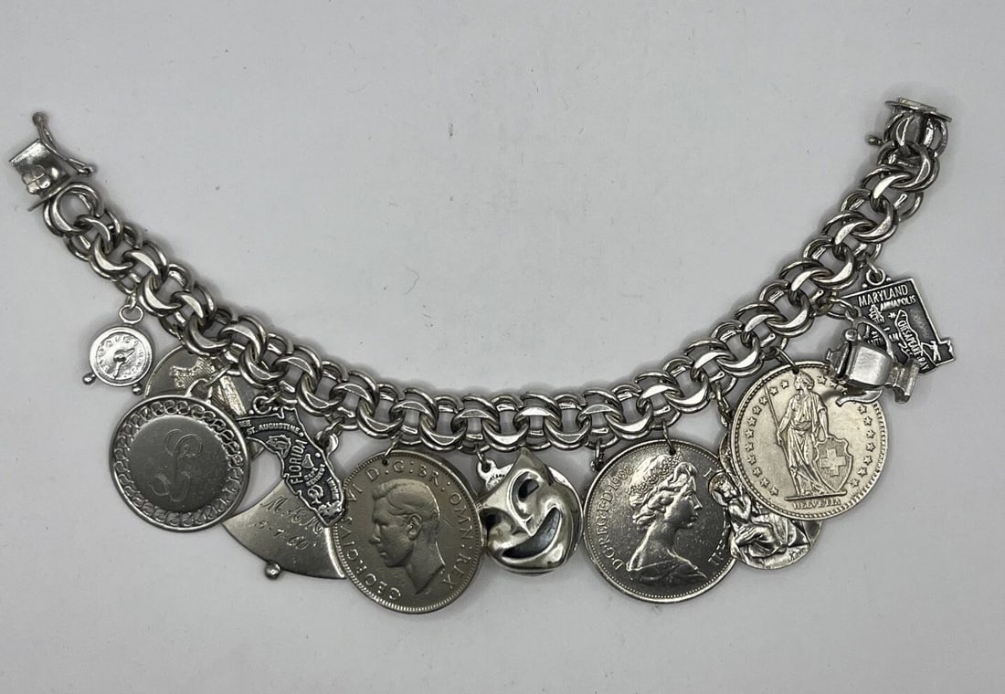 STERLING SILVER CHARM BRACELET WITH 13 CHARMS: STERLING SILVER CHARM BRACELET WITH 13 CHARMS STERLING SILVER CHARM BRACELET WITH 13 CHARMS Sterling Silver Charm Bracelet 7"Has 13 CharmsThe charms that have engravings on them we can remove them upo