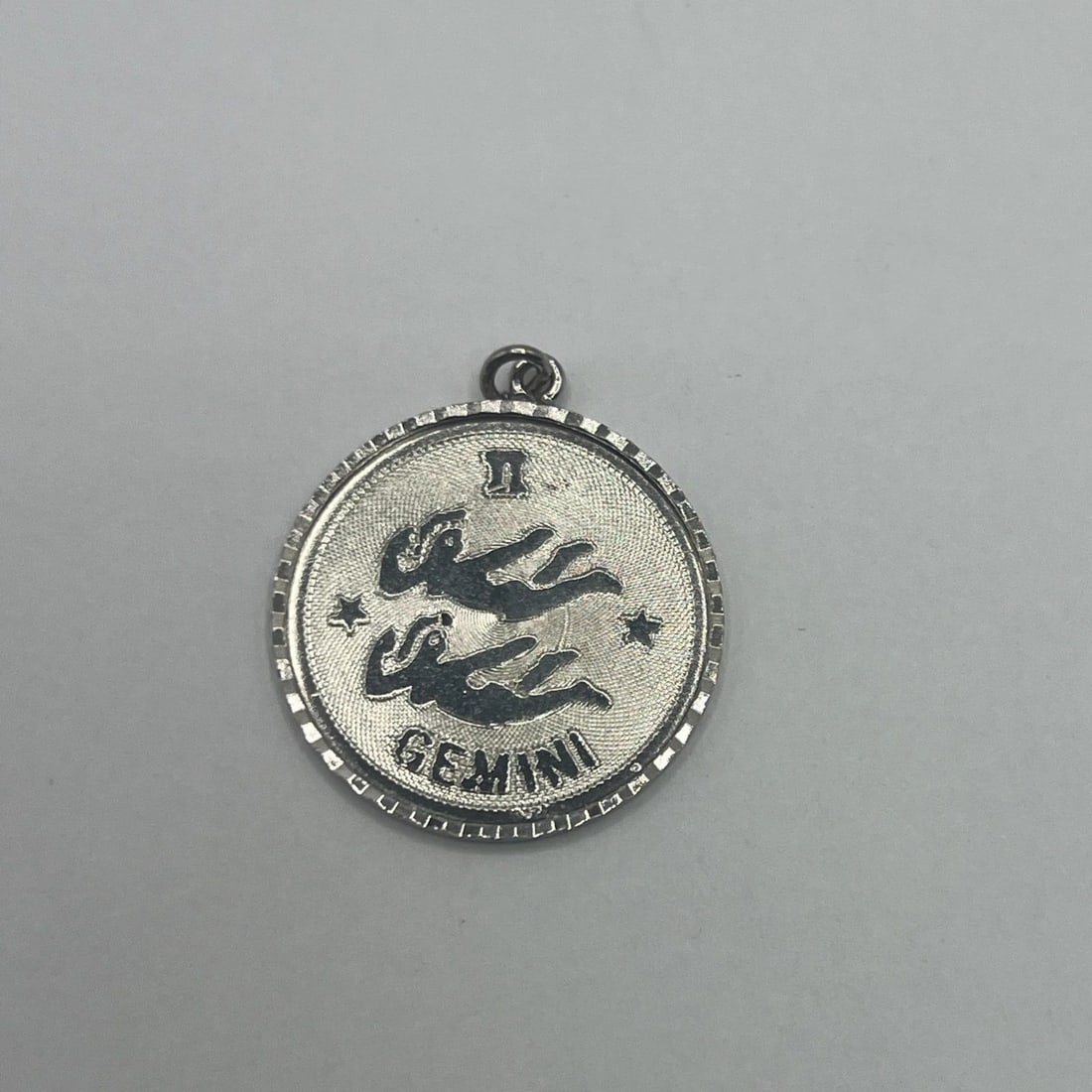 GEMINI STERLING SILVER CHARM: GEMINI STERLING SILVER CHARM GEMINI STERLING SILVER CHARM The "Gemini Sterling Silver Charm" is a charm made of 925 sterling silver featuring the zodiac sign Gemini. It is designed as a versatile piec
