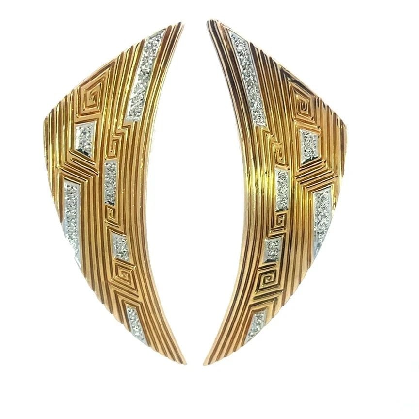 ERTE GOLD DIAMOND EARRINGS 14K TWO TONE LONG CURVED WING SHAPE: ERTE GOLD DIAMOND EARRINGS 14K TWO TONE LONG CURVED WING SHAPE This is a chic pair of Erte gold diamond earrings with a unique long curved wing shape and grooved lines. These 14k yellow gold with whit