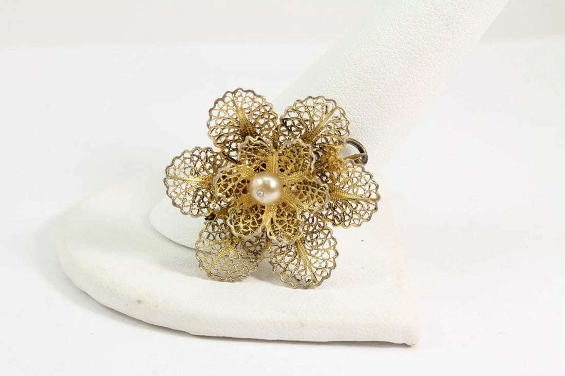 TOPAZIO PORTUGAL STERLING SILVER W/ GOLD VERMEIL FILIGREE PEARL FLOWER BROOCH: TOPAZIO PORTUGAL STERLING SILVER W/ GOLD VERMEIL FILIGREE PEARL FLOWER BROOCH Description Vintage Topazio Portugal Sterling Silver w/ Gold Vermeil Filigree Pearl Flower Brooch Item is in good conditio