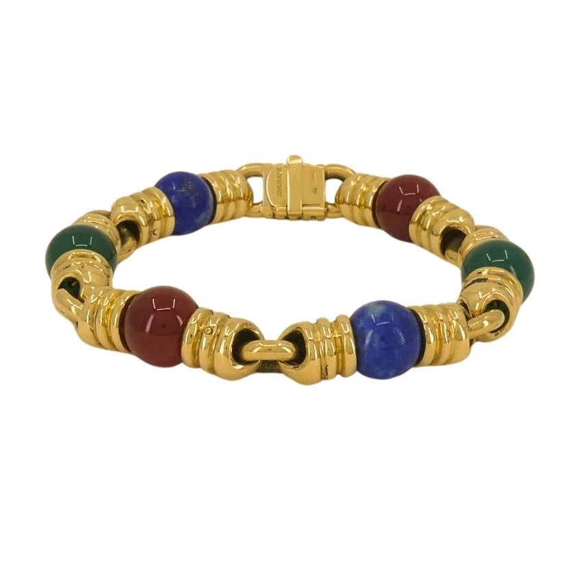 BVLGARI VINTAGE BULGARI BRACELET 18K GOLD GEMSTONES: BVLGARI VINTAGE BULGARI BRACELET 18K GOLD GEMSTONES A vintage Bulgari bracelet crafted of 18k gold, featuring gemstones. The bracelet alternates between rounded beads and geometric gold links that fee