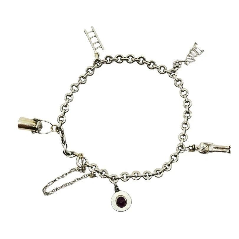 VINTAGE PLATINUM CHARM BRACELET DIAMOND GEMSTONE: VINTAGE PLATINUM CHARM BRACELET DIAMOND GEMSTONE Product details: MATERIALS: Platinum WEIGHT: 17.4 Grams MEASUREMENTS: Length - 7 1/4" Charms - 1/2" ITEM DETAILS: Vintage Platinum Charm Bracelet Diamo
