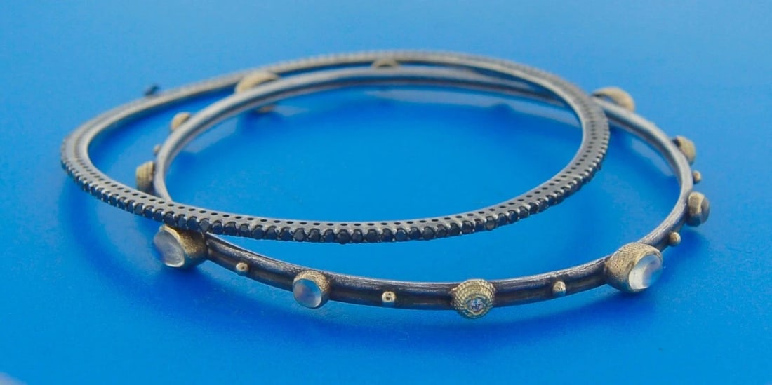 CHIC BLACK DIAMOND MOONSTONE YELLOW GOLD SLIVER BANGLE BRACELET - STYLISH PAIR: CHIC BLACK DIAMOND MOONSTONE YELLOW GOLD SLIVER BANGLE BRACELET - STYLISH PAIR A Pair of Moonstone Diamond 18 karat Yellow Gold Bangles Materials: silver (tested), 18k yellow gold, round black diamond