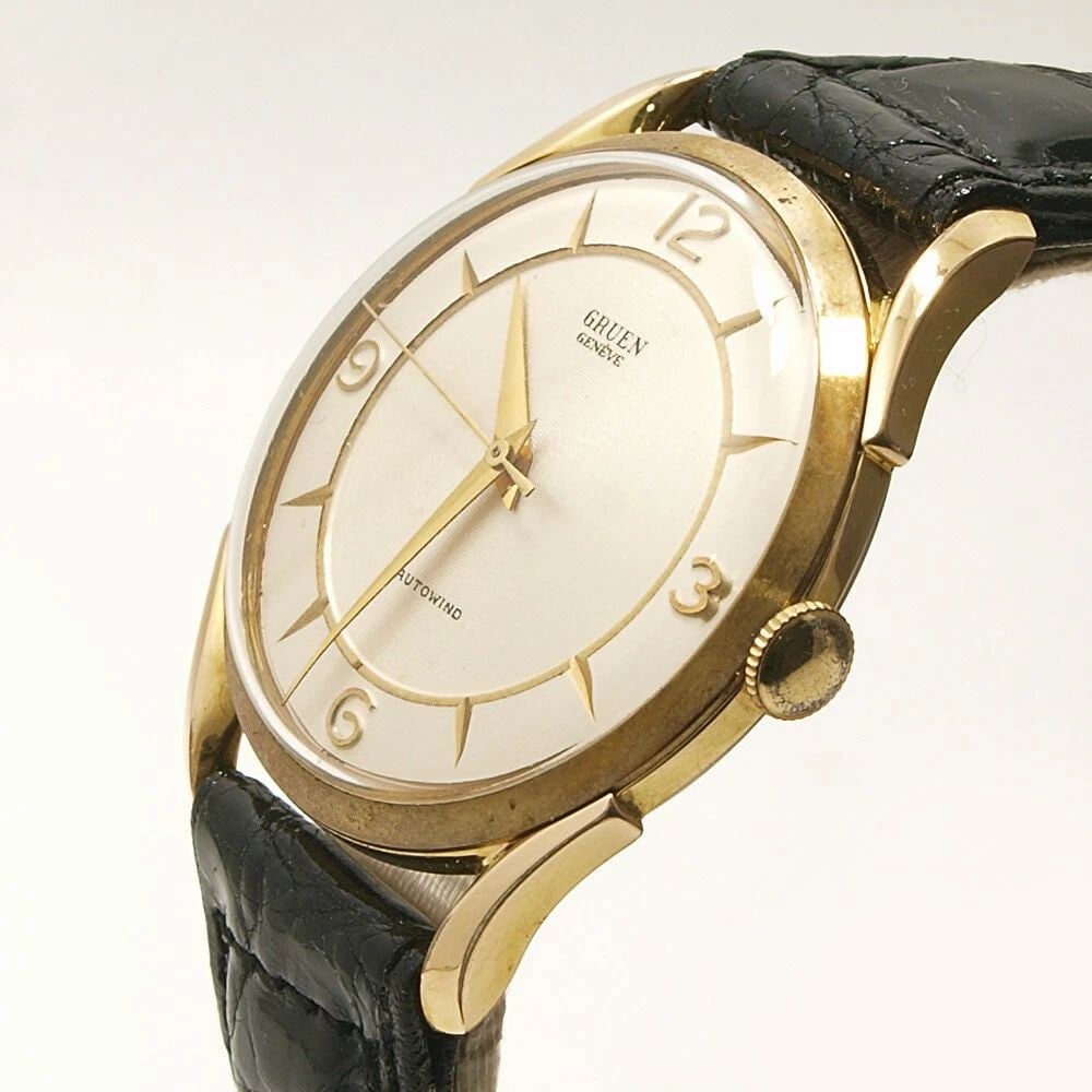 GRUEN ANALOG MEN'S WATCH: GRUEN ANALOG MEN'S WATCH Item Description Manufacturer: GruenType: Men'sName: RoundMaterial: 40-micron gold plating / stainless steel case backBand: Aftermarket leather band / Aftermarket gold-plated