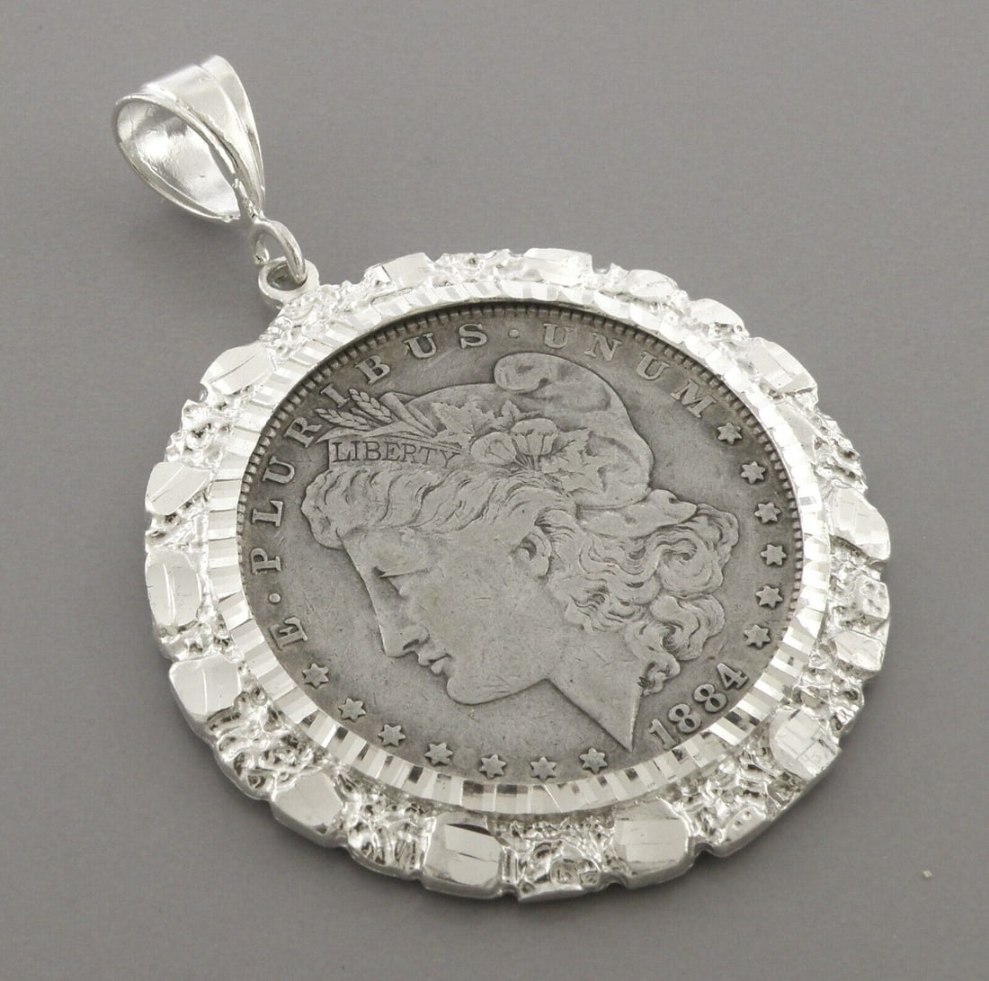 VINTAGE 1884 MORGAN DOLLAR COIN SILVER NUGGET PENDANT: VINTAGE STERLING SILVER COIN Vintage 1884 silver morgan dollar set in a nugget bezel pendant Measures 1.86" wide Coin is in good condition for it's age Vintage, Pre-owned, in good condition, please re